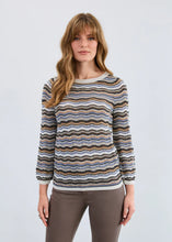 Load image into Gallery viewer, Woman wearing a striped sweater  and grey pants against a plain background.
