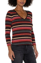 Load image into Gallery viewer, This three-quarter sleeve V-neck top features contrast striping in versatile colors of black, yellow gold, rose pink, and white. The fabrication has a silky high-quality substantive feel with great stretch. Our Tori is an ideal style to wear on its own or under a blazer, jacket, or cardigan for a polished look. Complete the ensemble with black trousers or blue jeans.  Colors- Black, white, rose pink and yellow gold. Three quarter sleeves. V-neck. Contrast striping.
