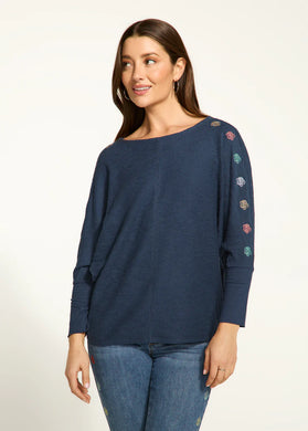 The Nessie Navy Batwing Top from FDJ French Dressing showcases intricate and vibrant floral details along the outer edge of the sleeves, adding an appealing and unique touch to any ensemble. The loose-fitting batwing design ensures a comfortable and stylish look, suitable for any occasion.