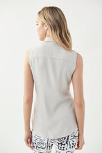 Load image into Gallery viewer, The fabrication used to create this gorgeous top by Joseph Ribkoff is absolutely amazing.  The flowy texture and lightweight feel make it an ideal top for summer styling.  A timeless design which includes button down with a fabric that softly drapes and then can be tied in the middle. Color- Moonstone. Self-tie. Button down. Sleeveless. No pockets. Not lined. Fabric - 100% Polyester.
