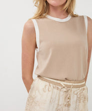 Load image into Gallery viewer, Close-up of woman wearing a sand-colored sleeveless top with off white contrast and safari print shorts against a white background.
