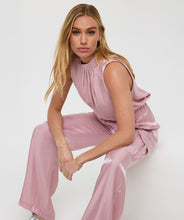 Load image into Gallery viewer, Sleek, soft, and summer-ready—the Svea Halter Top brings effortless elegance to any warm-weather look. Crafted from EsQualo’s signature silky-touch fabric in a dreamy pastel pink, it features a halter neckline with delicate gathering and a flowing, relaxed silhouette. Lightweight and breezy, it’s perfect for layering under a blazer or pairing with the matching silky cargos for a chic tonal ensemble.
