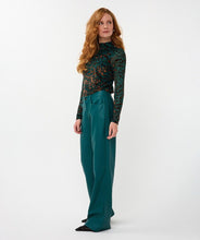 Load image into Gallery viewer, Woman wearing an animal print top in burnout velvet in teal and brown and teal pants against a white background.
