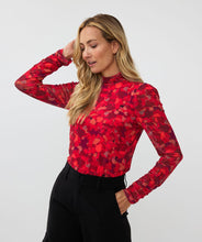 Load image into Gallery viewer, Who says winter has to be drab? Enhance your winter wardrobe with a touch of color. This stunning top features a vibrant multi color design that pairs well with denim or black pants. Wear it solo or layer it under a black blazer for a sophisticated look.
