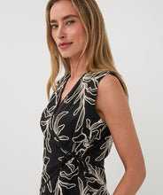 Load image into Gallery viewer, Woman wearing a black sleeveless top with off-white floral embroidery against a white background.
