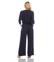 Load image into Gallery viewer, Our best-selling jumpsuit is now available in a beautiful navy color! Crafted from a high-quality, wrinkle-resistant jersey fabric, this jumpsuit is as low-maintenance as it is chic. Designed for the modern jetsetter, this jumpsuit combines comfort, style, and practicality for a seamless travel experience.
