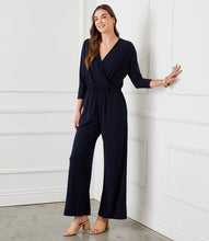 Load image into Gallery viewer, Our best-selling jumpsuit is now available in a beautiful navy color! Crafted from a high-quality, wrinkle-resistant jersey fabric, this jumpsuit is as low-maintenance as it is chic. Designed for the modern jetsetter, this jumpsuit combines comfort, style, and practicality for a seamless travel experience.
