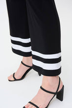 Load image into Gallery viewer, A gorgeous pant that will take you from day to evening, our Tatum trim detail pant in a striking black and white contrast, essentially pairs perfectly with so many of your favorite solid tops. A flared cut and contrast white trim create an eye-catching design that is not only fashionable but also flattering.   Colors - Black and vanilla. Pull-on style. Elastic waist. No pockets.
