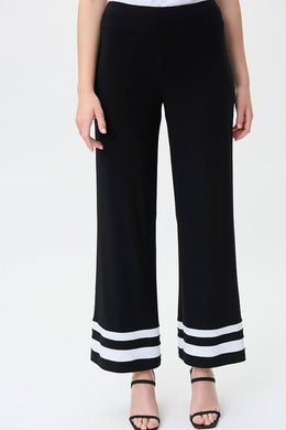 A gorgeous pant that will take you from day to evening, our Tatum trim detail pant in a striking black and white contrast, essentially pairs perfectly with so many of your favorite solid tops. A flared cut and contrast white trim create an eye-catching design that is not only fashionable but also flattering.   Colors - Black and vanilla. Pull-on style. Elastic waist. No pockets.