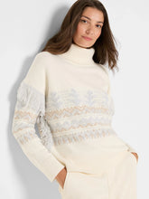 Load image into Gallery viewer, Woman wearing a cream and blue fringe detailed turtleneck sweater and cream pants against a white background.
