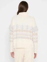 Load image into Gallery viewer, Woman wearing a cream and blue fringe detailed turtleneck sweater and cream pants against a white background.
