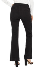 Load image into Gallery viewer, Model wearing long sleeve white top, black denim flare trousers and black heels against a white background.
