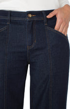 Load image into Gallery viewer, Close up of model wearing dark blue denim trouser pants against a white background.
