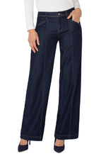 Load image into Gallery viewer, Model wearing dark blue denim trouser, blue heels and white top against a white background.
