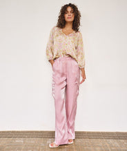 Load image into Gallery viewer, Slide into summer with these effortlessly chic silky cargos by EsQualo. Crafted in a soft pastel pink, they blend utility and elegance with a lightweight, flowy silhouette. Featuring an elastic waistband, side patch pockets, and a breezy wide-leg cut, these trousers are perfect for sunny strolls, weekend getaways, or dressing up with a strappy heel.
