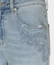 Load image into Gallery viewer, Close-up of embroidery on light blue jeans against a white background.
