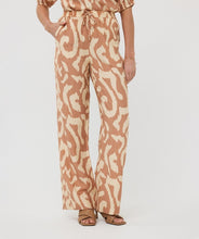 Load image into Gallery viewer, The EsQualo Trousers Solar Swing are stylish and comfortable pants featuring an all-over print design, wide legs, and side pockets for functionality. They come with two welt pockets at the back and an elastic waistband with a drawstring, accented with gold beading for a chic touch. A perfect pant for warm days, the Toma offers a lightweight and breathable fit.
