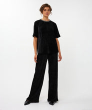 Load image into Gallery viewer, Model wearing a black outfit on a white background.
