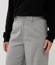 Load image into Gallery viewer, Model wearing grey pants and black sweater against a white background.
