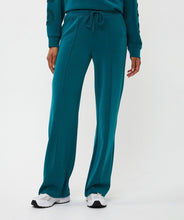 Load image into Gallery viewer, Teal modal wide leg pants and white sneakers against a light gray background.
