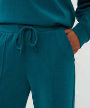 Load image into Gallery viewer, Close-up of teal pant and drawstring at waist against a white background.
