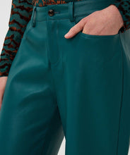 Load image into Gallery viewer, Close-up of the front of the teal faux leather pant worn by a model against a white background.
