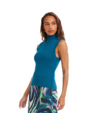 Load image into Gallery viewer, Woman wearing a teal blue sleeveless ribbed turtleneck knit top and colorful skirt against a white background.
