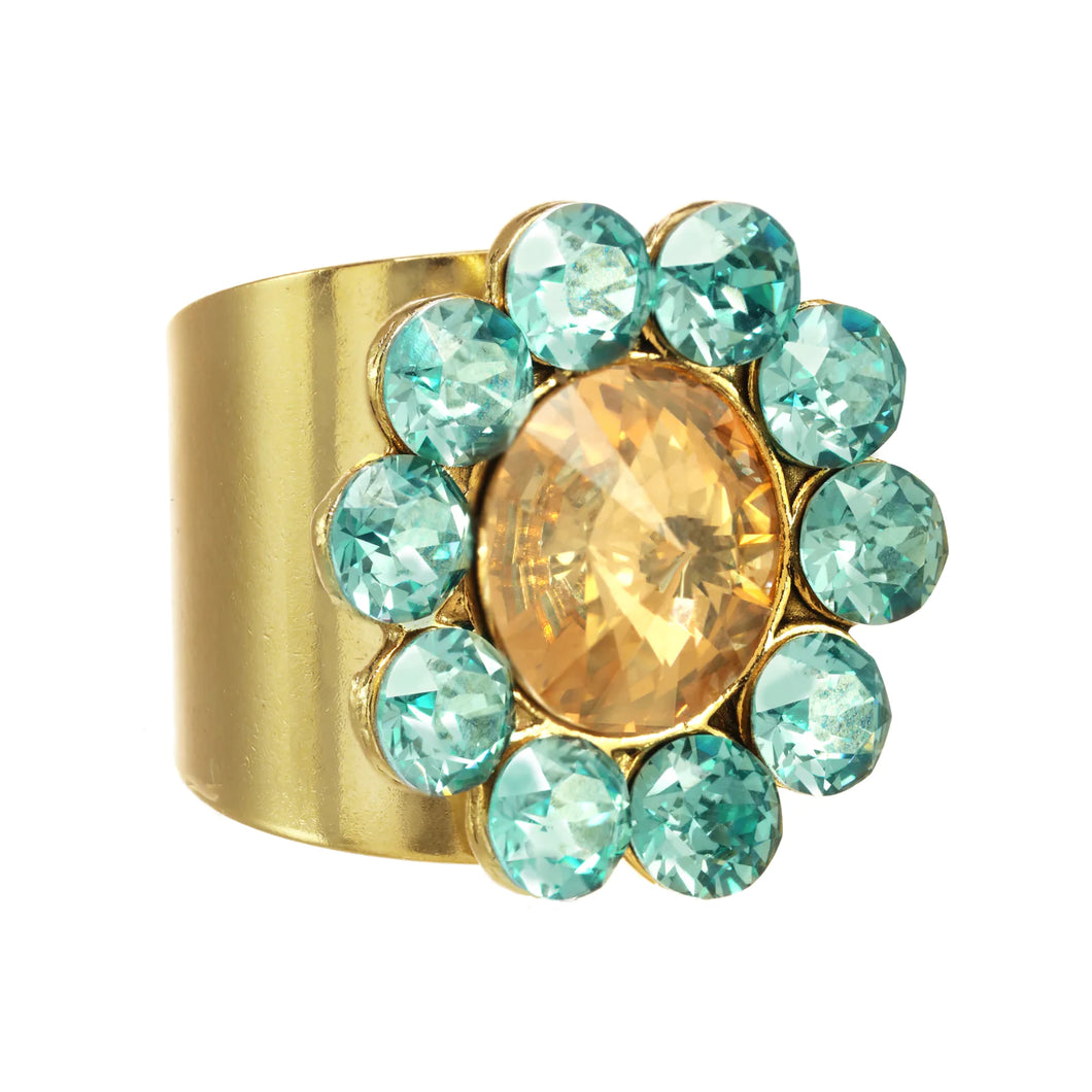 Add a glamorous touch to your style with the Twiggy Ring. This beautiful piece is crafted with superior crystals in an exquisite aqua and champagne color palette. The antique gold-plated brass and pewter base metal finish the piece off for a stunning look. Additionally, its adjustable fit ensures a comfortable wear.  Color- Aqua, champagne and gold. Premium crystals. Antique gold plating over pewter base metal. One size, adjustable.