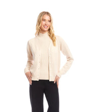 Load image into Gallery viewer, Woman wearing a coordinating beige turtleneck top and cardigan and black pants against a white background.

