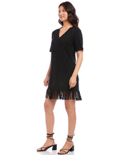 Load image into Gallery viewer, A basic black dress has been elevated to new heights with a lush curtain of fringe details at the hem. This comfortable dress is cut from stretch jersey-knit and can easily transition from brunch to dinner with a simple switch of shoes and accessories. Color - Black. Short sleeves. V-neckline. Fringe hemline. Fabric -90% Rayon. 10% Spandex.
