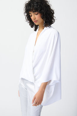 Our woven wrap top is a must-have garment that exudes confidence and grace. With dolman sleeves and a pleat detail at the neck, this top brings versatile style to your wardrobe, draping gracefully to flatter every body type.  Color- Vanilla. Woven fabric. Wrap neckline. Dolman sleeves. Pleated detail at the neck. Unlined.