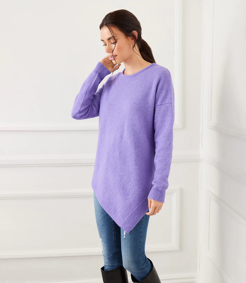 Revamp your everyday wardrobe with this super-soft violet sweater featuring a contemporary asymmetric hemline. Wear alone or layer underneath your favorite jacket.  Color - Violet. Long sleeve. Round neck. Rib detail. Asymmetric hemline.