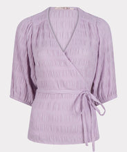 Load image into Gallery viewer, Equalize your fashion game with this stylish seersucker blouse in a show stopping violet. The wrap style and billowy elasticized elbow sleeves are perfect for creating a flattering silhouette. With its modern look and timeless quality, you&#39;ll be turning heads for seasons to come.

