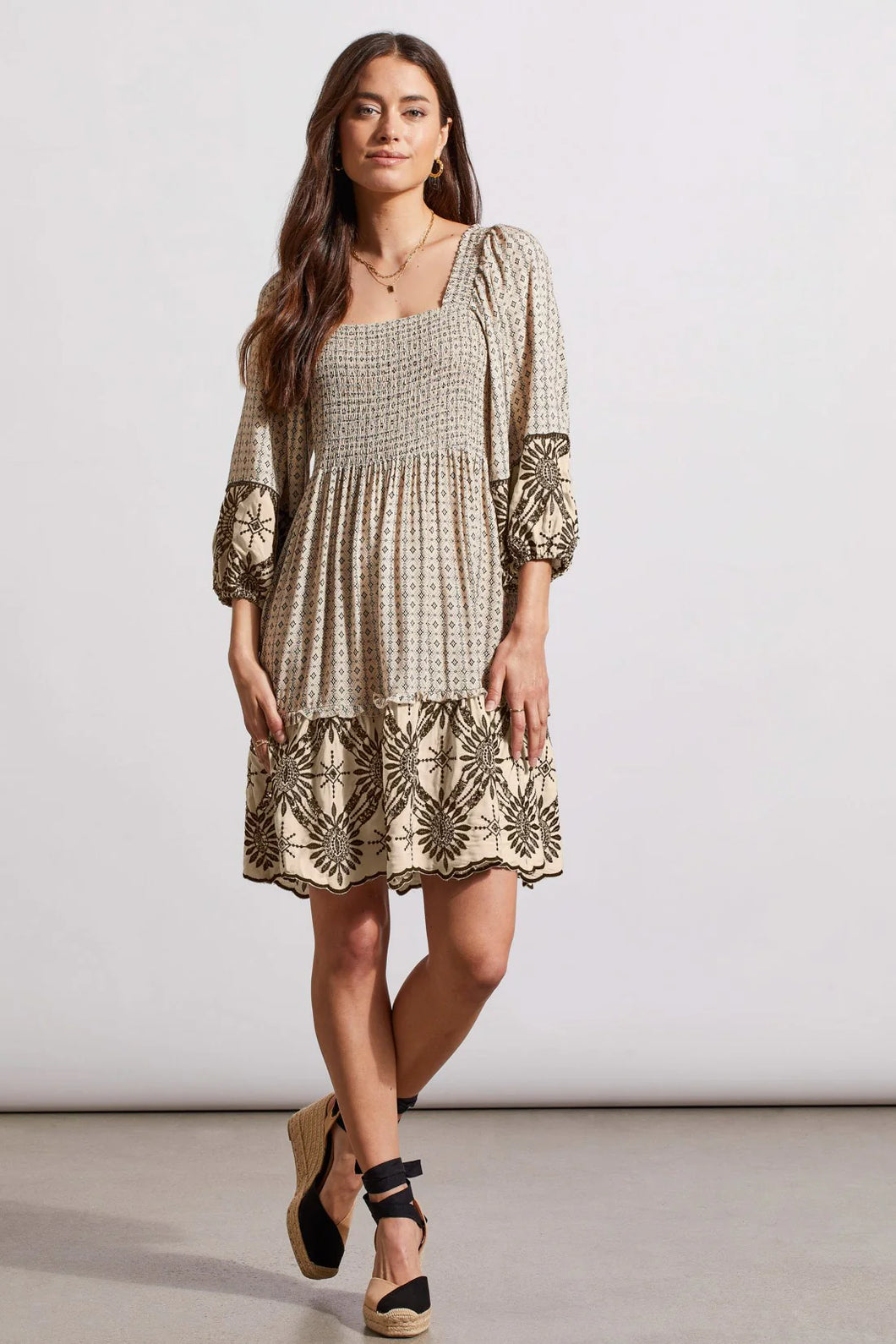 Utilize this versatile 2-in-1 dress, featuring a square front neckline and an adjustable tie-back closure, to add a personalized touch to your wardrobe. The reversible design allows for two distinct looks, while the flowy woven fabric, neutral print, and embroidered accents offer a polished yet versatile addition to any outfit.