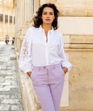 Load image into Gallery viewer, The Wita White Blouse Lace Sleeve by EsQualo features a striking openwork design on its sleeves, making it a standout choice. Its classic white color allows for versatile pairing with a variety of pants and skirts.
