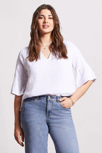 Load image into Gallery viewer, This lovely blouse is made of crinkled gauze cotton, which gives it a light and elegant touch. It features a notch neck that you can pop over, elbow-length raglan sleeves, and bell-shaped cuffs that add some playful charm.
