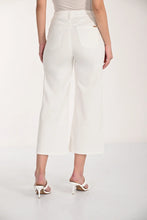Load image into Gallery viewer, White crop pants and white sandals worn by a model on a white background.
