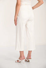 Load image into Gallery viewer, White crop pants and white sandals worn by a model on a white background.

