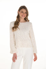 Load image into Gallery viewer, Woman wearing a white sparkle top and white pants against a white background.
