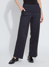 Load image into Gallery viewer, Model wearing dark plaid pants and black loafers against a white background.
