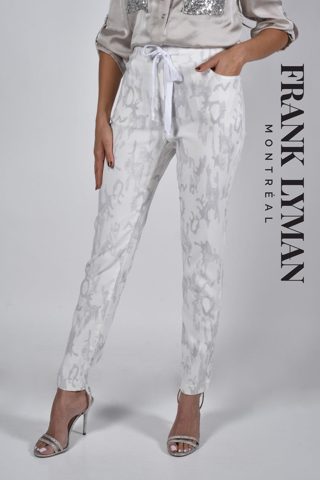 A true beauty, the Cora pant by Frank Lyman is not only fashionable but has such a beautiful feel.  A pull on with a drawstring, the subtle animal print in light gray sits atop a white background. Pair with a white tee or a silver/gray top and you will be able to conquer the day in comfort!