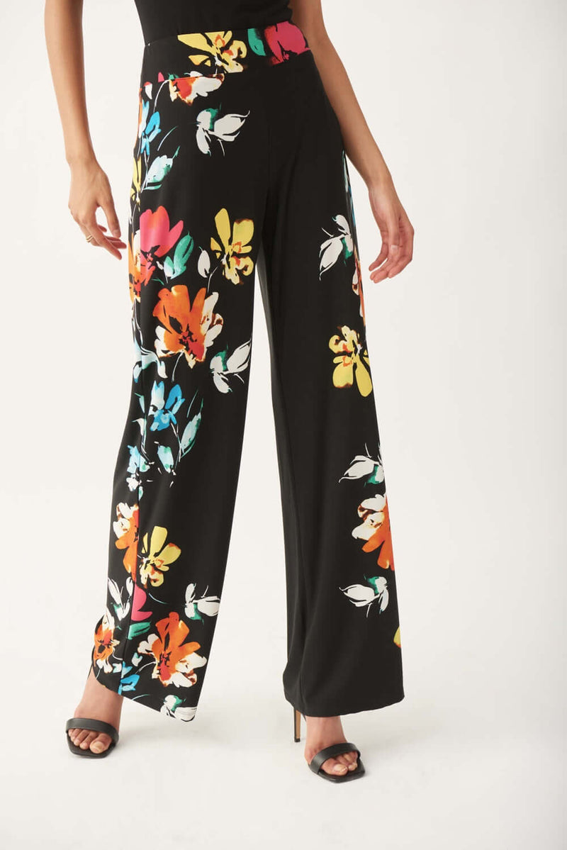 Our gorgeous Nalini floral pant by Joseph Ribkoff is pure comfort and fashion at the same time. With a bright, vibrant floral pattern, this wide leg pant is sure to get you compliments. The Nova has a pull-on fit and elasticized waistband, making it ultra-comfortable. The soft, silky knit fabrication has a luxurious feel.