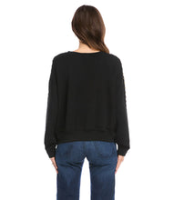Load image into Gallery viewer, This super soft fleece sweatshirt will keep you cozy warm during those chilly days. Detailed with brass studs for a dash of edge, this embellished sweatshirt pairs perfectly with your favorite denim. Color- Black. Long sleeve. Round neck. Brass stud embellishment.
