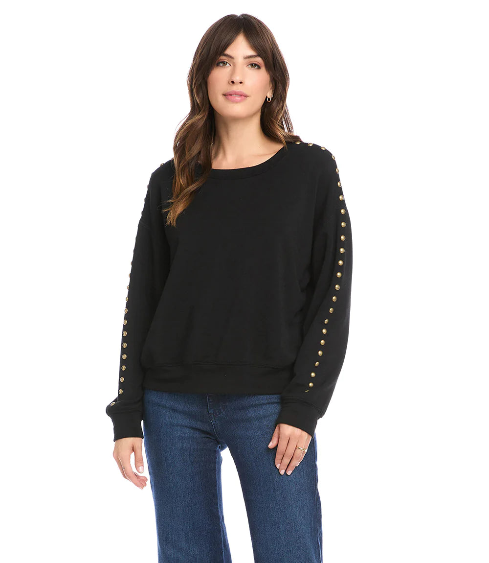 This super soft fleece sweatshirt will keep you cozy warm during those chilly days. Detailed with brass studs for a dash of edge, this embellished sweatshirt pairs perfectly with your favorite denim. Color- Black. Long sleeve. Round neck. Brass stud embellishment.