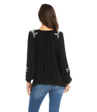 Load image into Gallery viewer, Lightweight gauze gives a breezy quality to this top detailed with charming floral embroidery. Flouncy tassel ties give it the perfect finishing touch.
