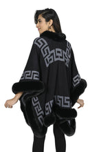 Load image into Gallery viewer, A fabulous cape will always elevate an outfit.  The knit Kalen Cape from Frank Lyman has faux fur trim and a single enclosure. A perfect alternative to wearing a jacket or coat, the Kalen can be worn with a dress for a special occasion or with your leggings and sweater for a trendy look.  Color- Black and grey. Faux fur trim. Geometric pattern. Single enclosure. Fabric-100% Acrylic.
