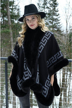 Load image into Gallery viewer, A fabulous cape will always elevate an outfit.  The knit Kalen Cape from Frank Lyman has faux fur trim and a single enclosure. A perfect alternative to wearing a jacket or coat, the Kalen can be worn with a dress for a special occasion or with your leggings and sweater for a trendy look.  Color- Black and grey. Faux fur trim. Geometric pattern. Single enclosure. Fabric-100% Acrylic.
