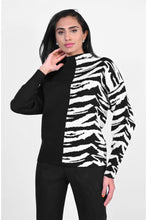 Load image into Gallery viewer, Black and white contrast with half zebra pattern, creates a chic and sophisticated sweater by Frank Lyman.  This modish style pairs beautifully with almost any bottom. Prepare to receive many compliments when you wear this cozy, fashionable sweater.  Color- Black and white. Half solid, half zebra print. High neck. Pull-over. Cozy.
