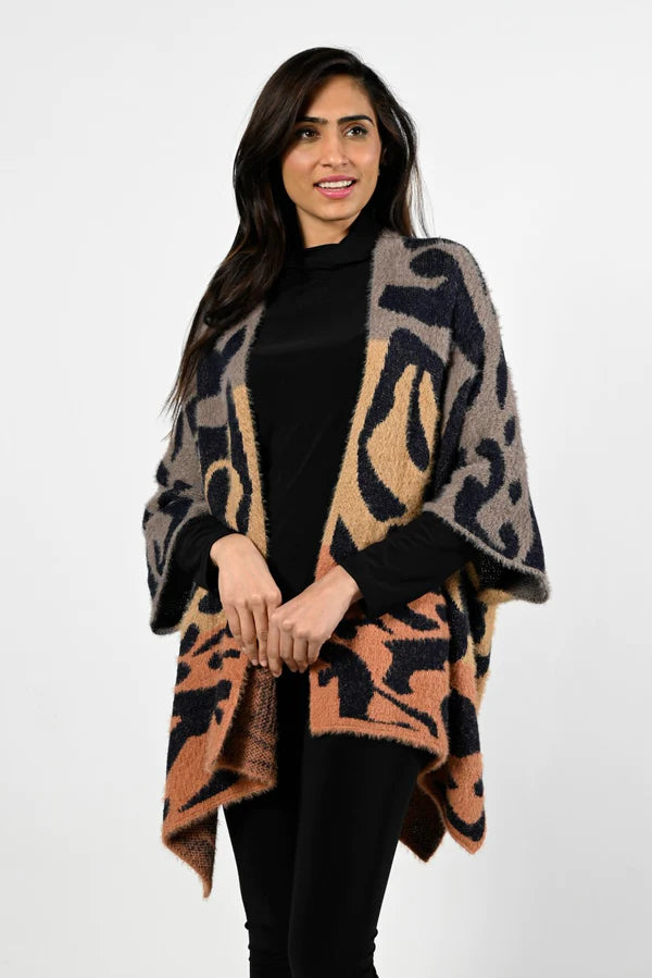 A striking abstract print in orange, black and brown comes alive on this stunning cardigan.  Fuzzy, cozy and warm, this fabulous cardigan will become your next cold weather favorite.  
