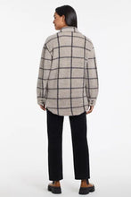 Load image into Gallery viewer, This season, we adore shackets, which are so on trend. This soft brushed plaid version is one of our favorites, thanks to the classic button-front closure, shirt collar, chest patch pockets, and curved shirttail hem that combine to create a piece that will keep you warm and stylish at the same time.    Color- Taupe grey. Relaxed fit. Chest patch pockets. Curved shirttail hem.
